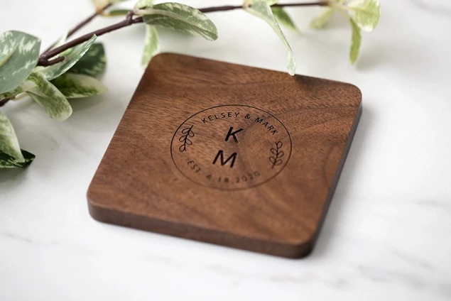 Set of four rounded edge Walnut Tyndell Wood Coasters with logo engraving.